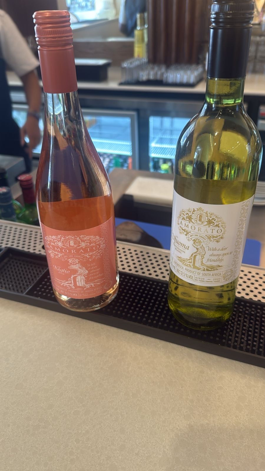 Amorato Kigho Rosé and Ufuoma Sauvignon Blanc bottles on a bar counter